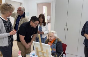 Karen and Joshua with a resident of the Haifa Home for Holocaust survivors in the art and crafts room.