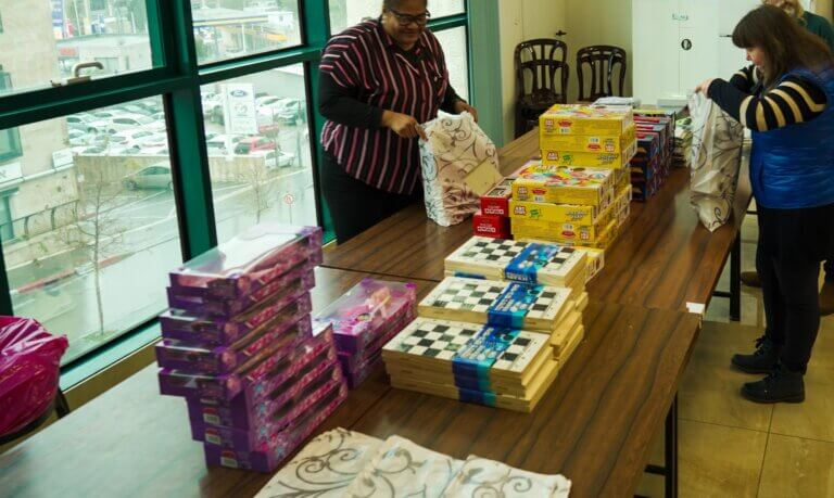 ICEJ staff members pack toys at Headquarters in Jerusalem (ICEJ Photo)